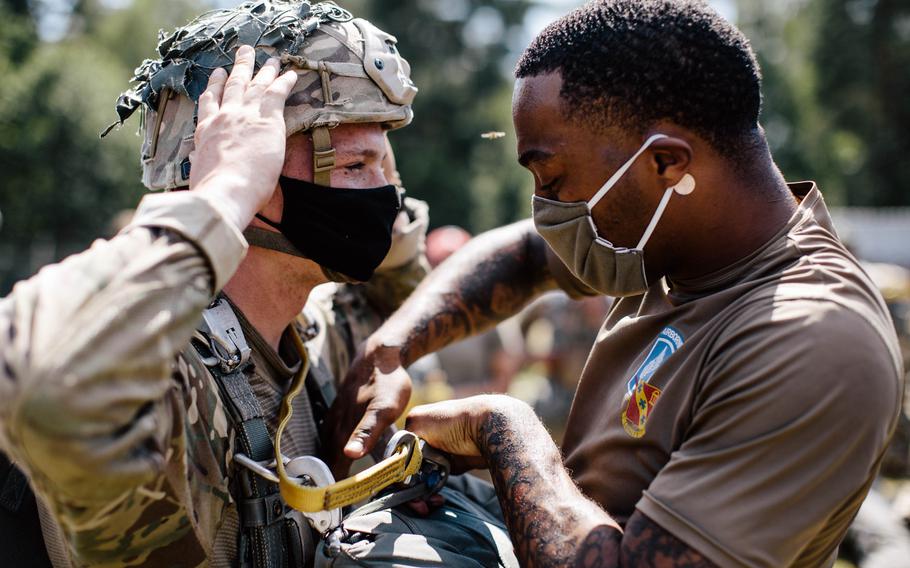 U.S. paratroopers assigned to the 173rd Airborne Brigade conduct inspections prior to a jump at Grafenwoehr Training Area, Germany, July 23, 2020.