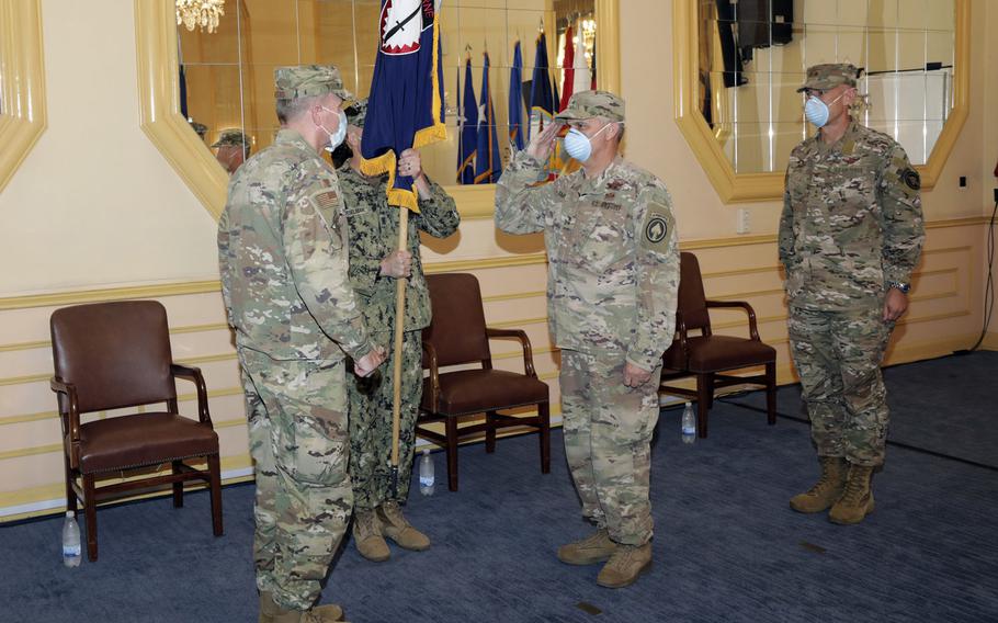 Outgoing Special Operations Command Europe commander Maj. Gen. Kirk W. Smith, center, salutes Gen. Tod D.  Wolters, commander U.S. European Command, as incoming SOCEUR commander Maj. Gen. David H. Tabor watches during the change of command ceremony in Stuttgart, Germany, Aug. 3, 2020. All three are U.S. Air Force officers.