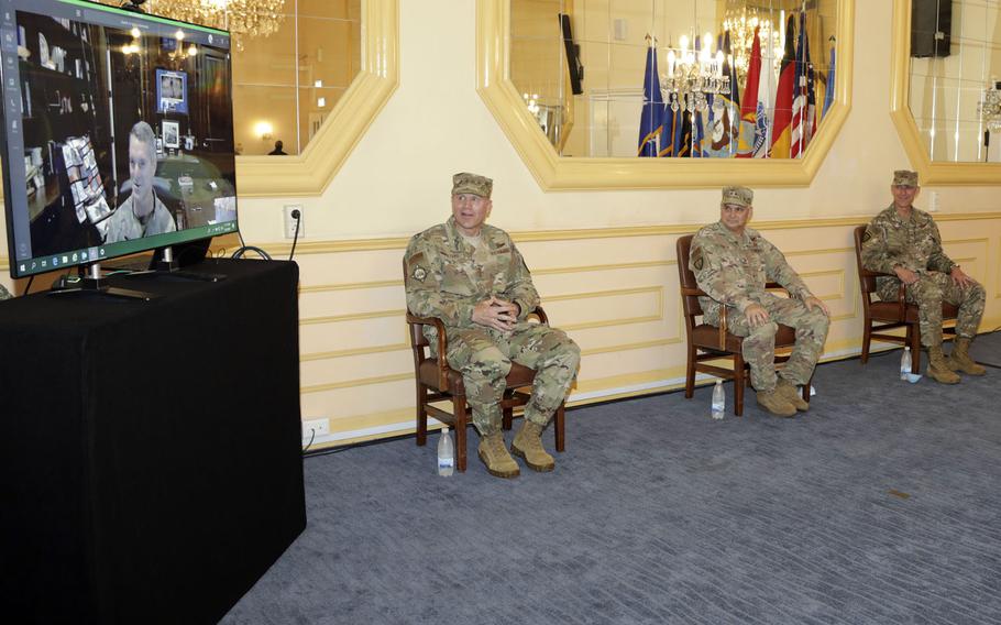 Gen. Tod D. Wolters, head of U.S. European Command,  Special Operations Command Europe outgoing commander Maj. Gen. Kirk W. Smith and incoming commander Maj. Gen. David H. Tabor listen to Gen. Richard D. Clarke,
commander of U.S. Special Operations Command who is taking part virtually at the change of command ceremony in Stuttgart, Germany, Aug. 3, 2020.