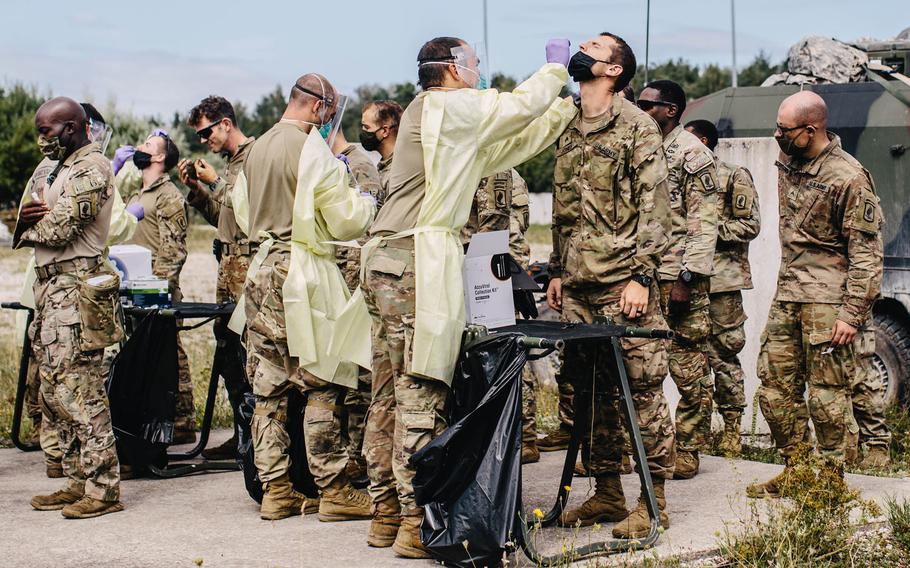 U.S. Army medic paratroopers assigned to 1st Battalion, 503rd Infantry Regiment, 173rd Airborne Brigade swab soldiers for the coronavirus during surveillance testing of the brigade in Hohenfels Training Area, Germany, Aug. 20, 2020, during Exercise Saber Junction 20.