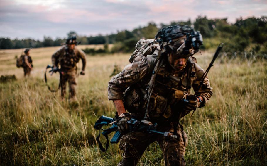 U.S. Army paratroopers assigned to 1st Battalion, 503rd Infantry Regiment, 173rd Airborne Brigade move towards a fighting position during the assault of a city at Hohenfels Training Area, Germany, Aug. 20, 2020, during Exercise Saber Junction 20. Tests conducted on the soldiers before, during and after the exercise, all came back negative for the coronavirus.