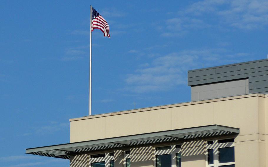 The American flag flies over the U.S. embassy in Berlin, Germany. The embassy is getting involved in a dispute with Germany over whether troops and Defense Department civilians who have NATO Status of Forces Agreement protections, are obligated to pay German taxes.