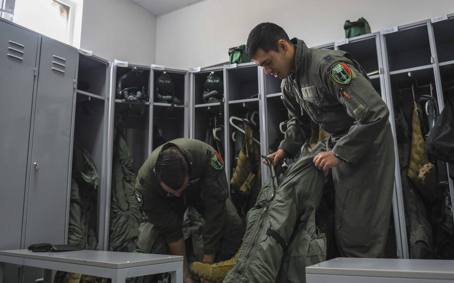 Two U.S. Air Force pilots from the 555th Fighter Squadron, Aviano Air Base, Italy, put on gear at Graf Ignatievo Air Base, Bulgaria, Sept. 21, 2020. The pilots participated in Thracian Viper 20, a multilateral training exercise with the Bulgarian air force.