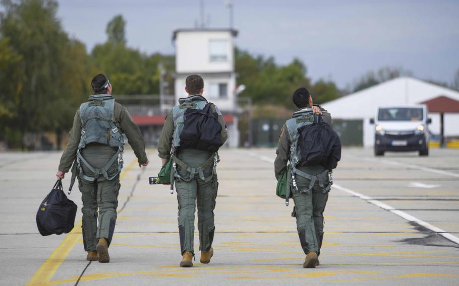 Three U.S. Air Force pilots from the 555th Fighter Squadron, Aviano Air Base, Italy, walk toward their aircraft at Graf Ignatievo Air Base, Bulgaria, Sept. 21, 2020. The pilots participated in Thracian Viper 20, a multilateral training exercise.