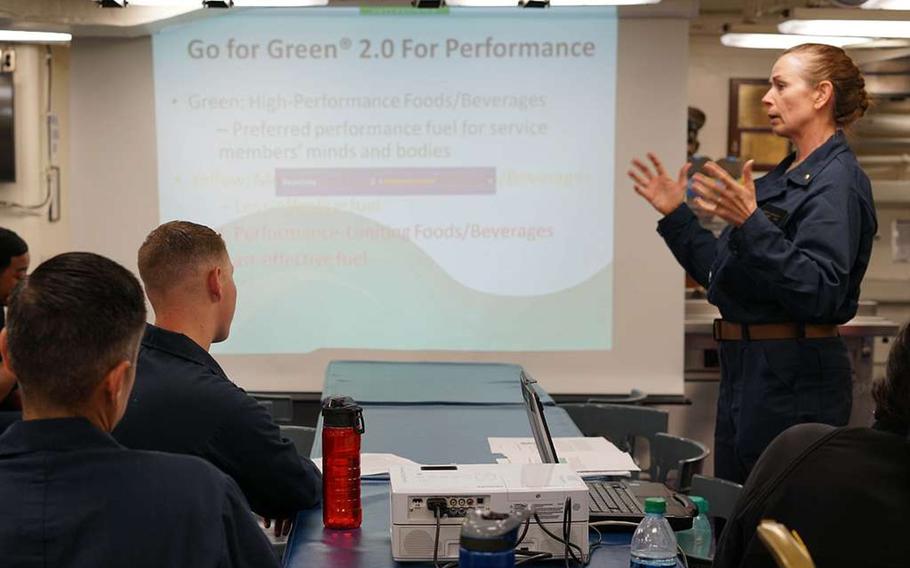 Navy registered dietitian Lt. Pamela Gregory teaches sailors aboard the destroyer USS John Finn about the Go for Green 2.0 program during her seven-day temporary duty assignment to educate sailors on performance nutrition, healthy eating habits, hydration and safe dietary supplement use, Nov. 11, 2018.