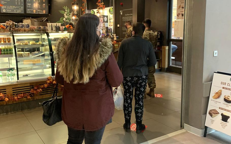 Members of U.S. Army Garrison Bavaria stand away from each other as they wait to order at the Starbucks on Tower Barracks, Grafenwoehr, Germany. The garrison restricted the size of social gatherings on Nov. 2, 2020, in an effort to flatten the curve of a second wave of the coronavirus in Germany.