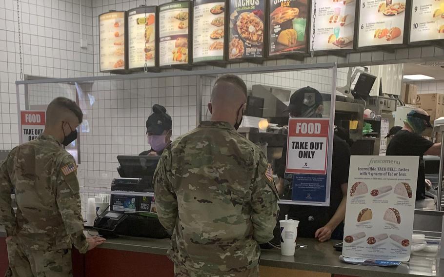 U.S. soldiers order fast food on Tower Barracks in Grafenwoehr, Germany, Nov. 2, 2020, where a sign reads ''Takeout Only.'' Eateries are restricted to providing only takeout or delivery meals starting Nov. 2, 2020, as U.S. Army Garrison Bavaria toughened up coronavirus rules to try to flatten the curve of a second wave in Germany.