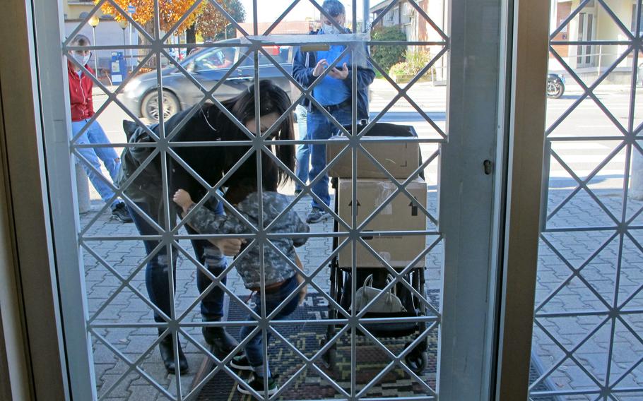 Customers line up outside the U.S. Army Garrison post office in Vicenza, Italy, on Friday, Nov. 7, 2020. Mailing parcels has become more time-consuming since the post office switched to online customs forms.