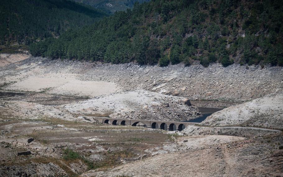 The normally submerged bridge of the one-time village of Aceredo is seen after emerging due to the low water level of the Lindoso reservoir, near Lobios, Spain, on Aug. 25, 2022.