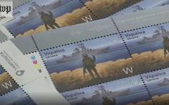A video screen grab shows stamps depicting a Ukrainian border guard displaying his middle finger to a Russian warship.