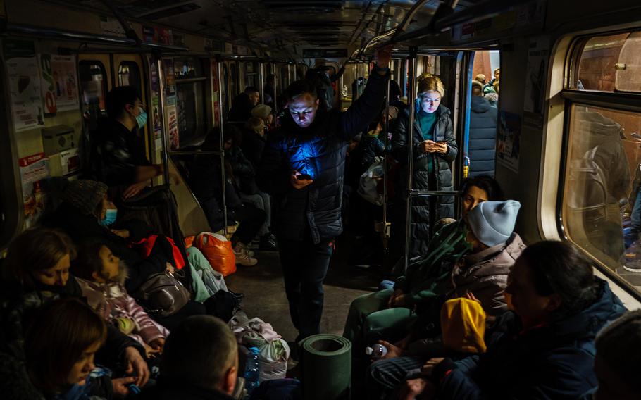 Hundreds of people seek shelter underground, on the platform, inside dark train cars, and even in the emergency exits, in metro subway station as the Russian invasion of Ukraine continues, in Kharkiv, Ukraine, Thursday, Feb. 24, 2022.