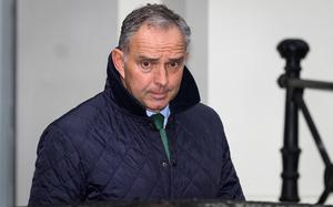 A man in a jacket walks after a meeting.