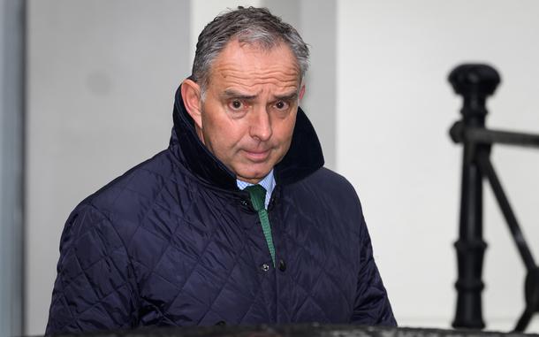 A man in a jacket walks after a meeting.