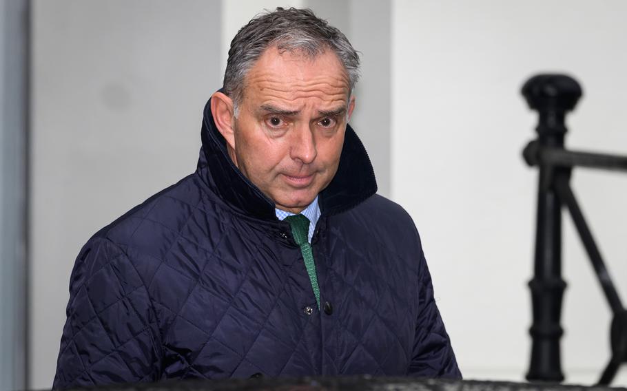 A man in a jacket walks after a meeting.