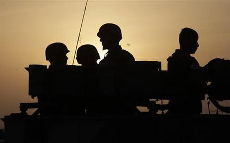 Afghan Army soldiers, pictured at Forward Operating Base Howz-e-Madad, operated jointly by the Afghan Army's 1st Battalion of the 3rd Brigade and the U.S. Army 2- 502 Infantry, 101st Airborne Division, in Zhari district, Kandahar province, southern Afghanistan, Saturday, Aug. 21, 2010. The 101st Airborne's 2-502 and their Afghan Army partners operate in a district which, as the birthplace of the Taliban movement, continues to hold many well-armed fighters, and a support network which provides the fighters with improvised explosives and safe havens.
