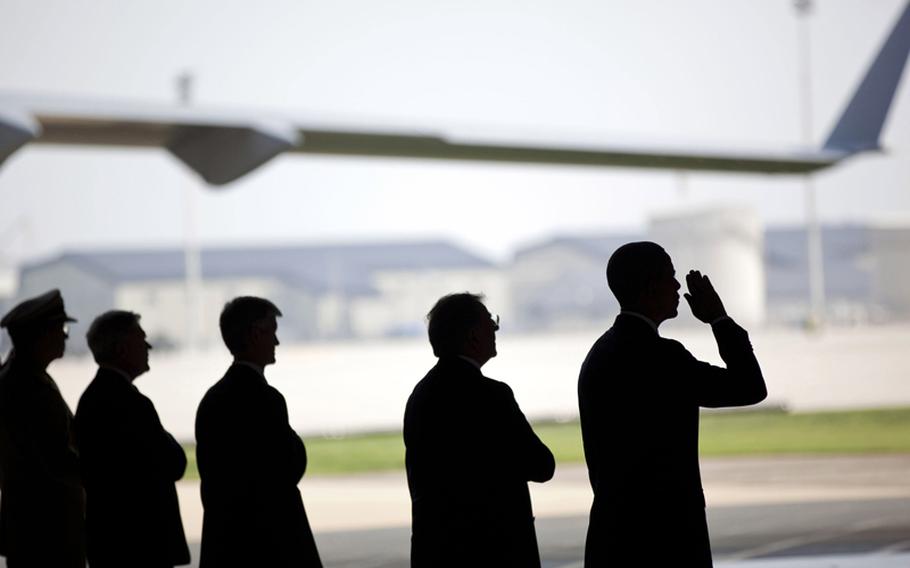 President Barack Obama, in the process of saluting, participates in a ceremony at Dover Air Force Base in Dover, Delaware on Tuesday, August 9, 2011, for the dignified transfer of U.S. and Afghan personnel who died in Afghanistan on August 6.
