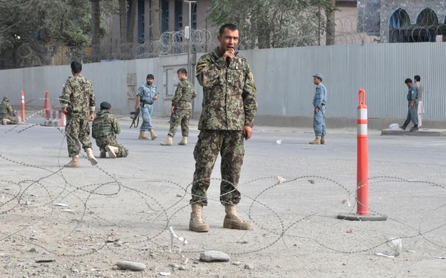 Afghan security forces set up a checkpoint outside the U.S. Embassy in Kabul after insurgents launched an attack on the compound Tuesday afternoon. AT least one Afghan police officer and two insurgents were reportedly killed in the fighting.