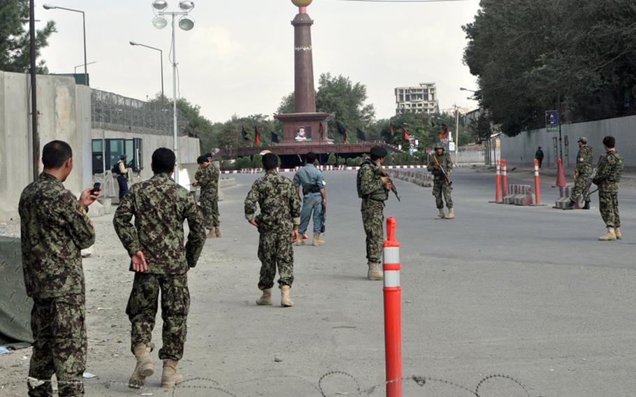 Insurgents attacked the U.S. Embassy in Kabul on Tuesday afternoon, firing rocket-propelled grenades and automatic weapons from the unfinished gray building seen in the background of this photo taken from an Afghan security checkpoint near the embassy.