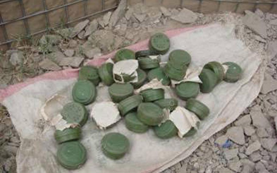 File -- Afghan National Security Forces, assisted by Coalition forces, find a weapons cache of 30 anti-personnel mines near Shadal Village, Sphingar District, Nangarhar Province in 2007. 


