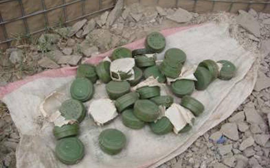 File -- Afghan National Security Forces, assisted by Coalition forces, find a weapons cache of 30 anti-personnel mines near Shadal Village, Sphingar District, Nangarhar Province in 2007.