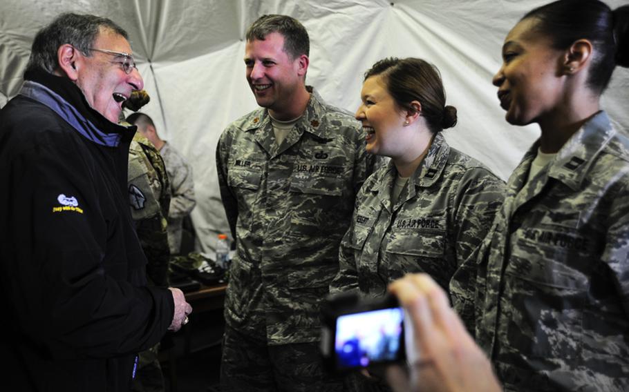 Secretary of Defense Leon Panetta shares a laugh with Maj. Brian Miller, Capt. Holly Gebert and Capt. Kay Stern on March 14, 2012, during a visit to the Transit Center at Manas, Kyrgyzstan. The airmen are deployed to the Transit Center’s Theater Security Cooperation division. Miller is deployed from the Pentagon, Gebert is deployed from Wright-Patterson Air Force Base, Ohio, and Stern is deployed here from Kirtland AFB, N.M.




Read more: http://www.dvidshub.net/image/541761/secdef-visit-transit-center#ixzz1p5yxPLVB