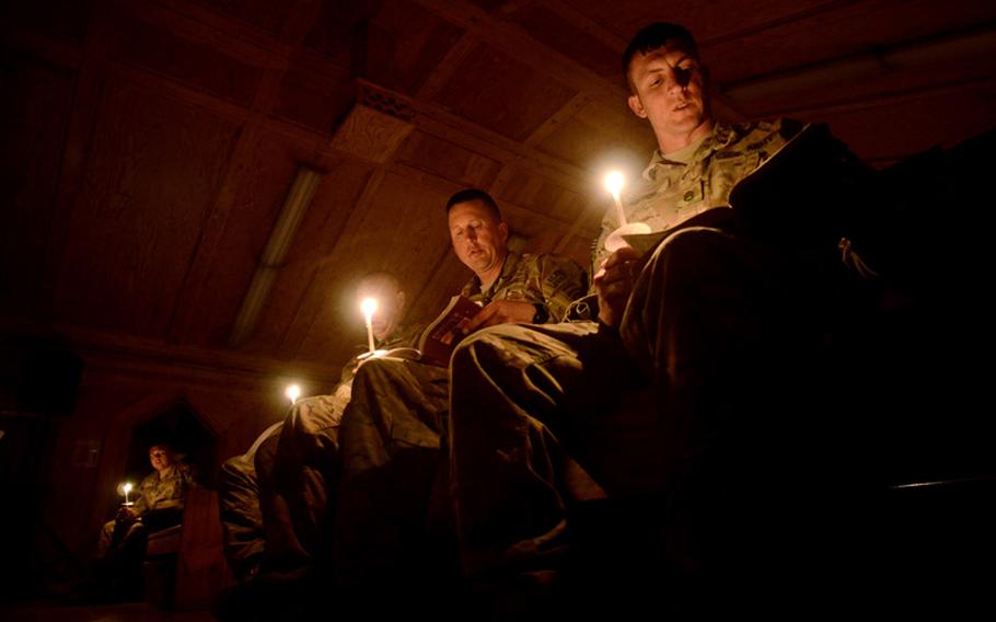 U.S. Army Staff Sgt. Dustin Mesch, right, Sgt. Maj. Michael Van Engen, middle,  and Maj. Brian Stoffle, with 4th Brigade, 25th Infantry Division, out of Anchorage, Alaska, were confirmed into the Catholic faith during the Easter vigil Saturday night in the chapel at Forward Operating Base Salerno, Afghanistan.