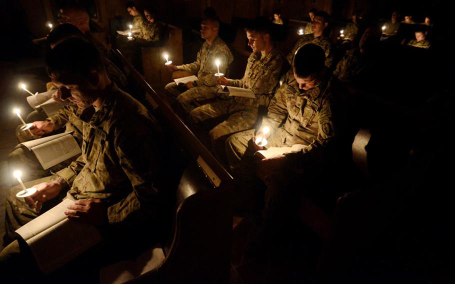 Around 26 soldiers and civilian contractors of the Catholic faith deployed to Forward Operating Base Salerno, Aghanistan, attend an Easter vigil to commemorate the life, death, passion and resurrection of Jesus Christ Saturday night.