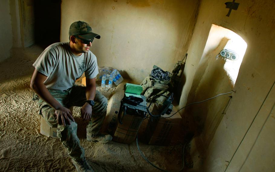 Spc. Alex Sweredoski with Company F, 4th Battalion, 101st Aviation Regiment, 159th Combat Aviation Brigade, 101st Airborne Division, mans a radio at Battle Position Osman near the village of Kuchnay Shur in Zabul province, Afghanistan, on Sept. 14, 2011.  The battle position was named after Staff Sgt. Ergin Osman, who was killed on May 26, 2011, in an improvised explosive device attack.
