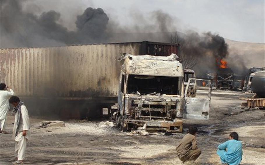 Burning NATO supply trucks are seen in Samangan, north of Kabul, Afghanistan on July 18, 2012. Afghan officials say a magnetic bomb placed on a truck exploded and destroyed 22 NATO supply vehicles in northern Afghanistan.