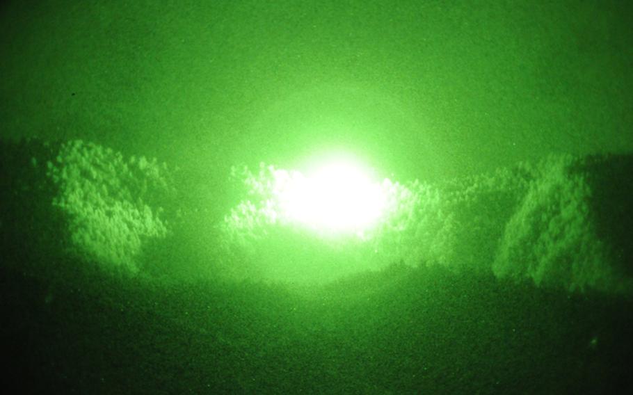 In this file photo from 2011, the explosion from an airstrike on an insurgent location near Jani Kheyl lights up the night sky.

