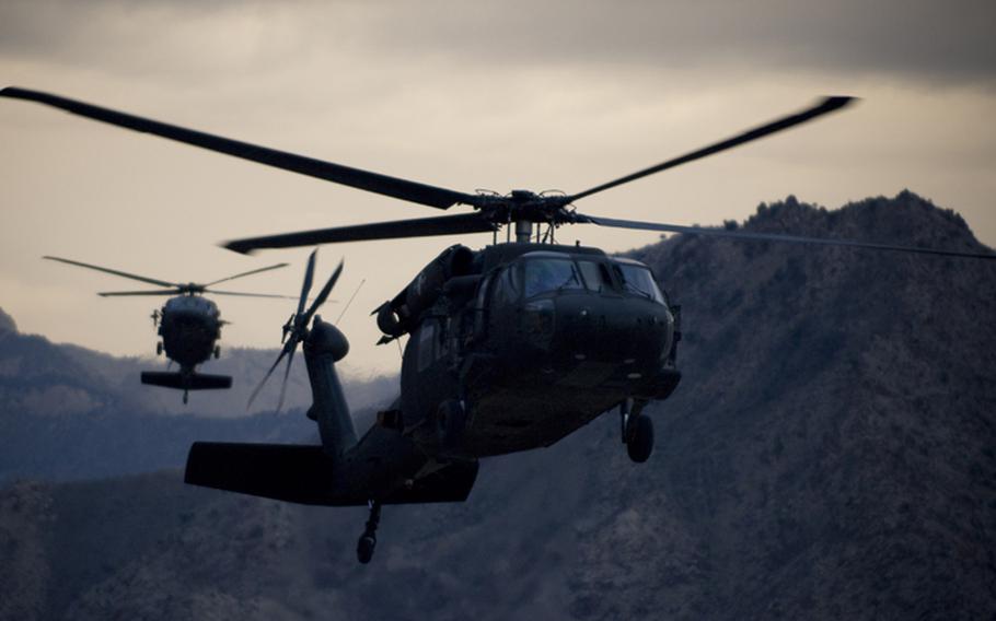 Two Army UH-60 Black Hawk helicopters prepare for landing at forward operating base Kalagush in Afghanistan in this September 2008 photo.