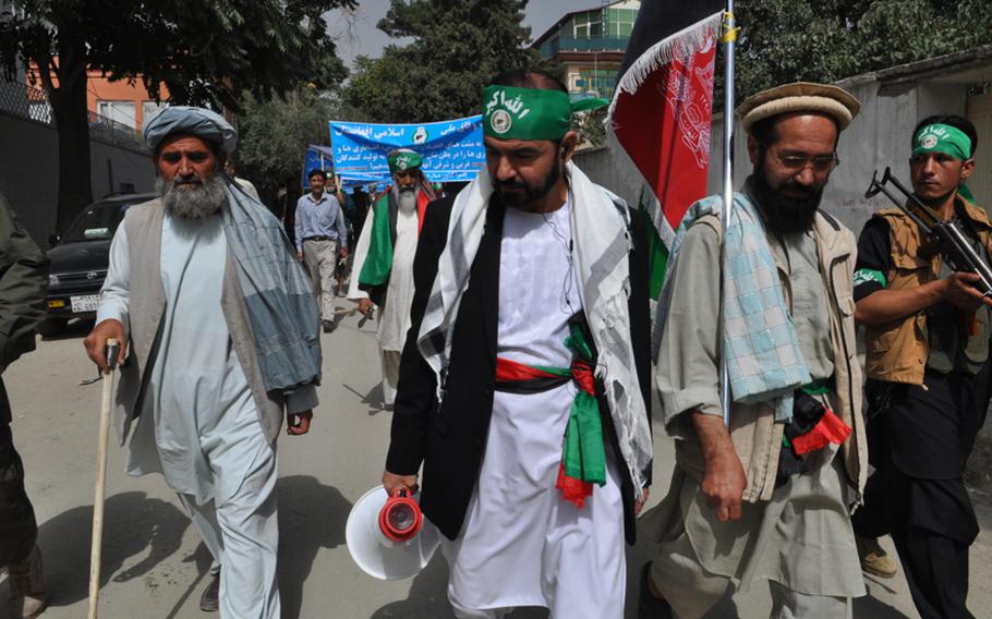 Former presidential candidate Bismillah Sher, with bullhorn, leads a demonstration against Pakistan on Sept. 16, 2012, as a group of volunteers makes its way to a convoy of cars that would take protestors close to the Pakistani border, where rocket attacks from Pakistan have chased thousands of villagers from their homes.