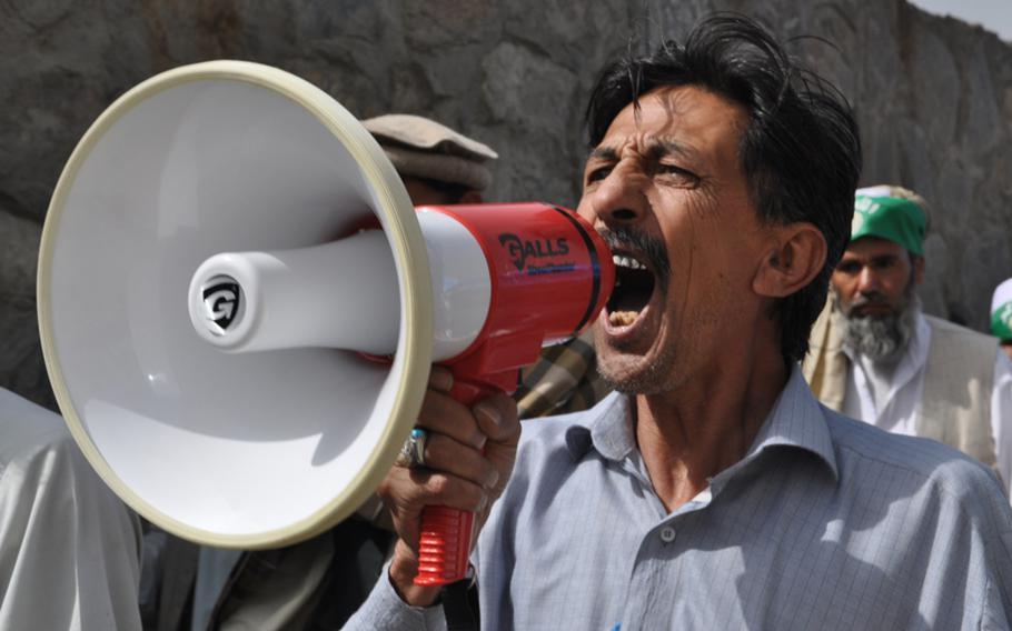 A protester chants slogans during a demonstration against Pakistan on Sept. 16, 2012, as a group of volunteers makes its way to a convoy of cars that would take them close to the Pakistani border, where rocket attacks from Pakistan have chased thousands of villagers from their homes.