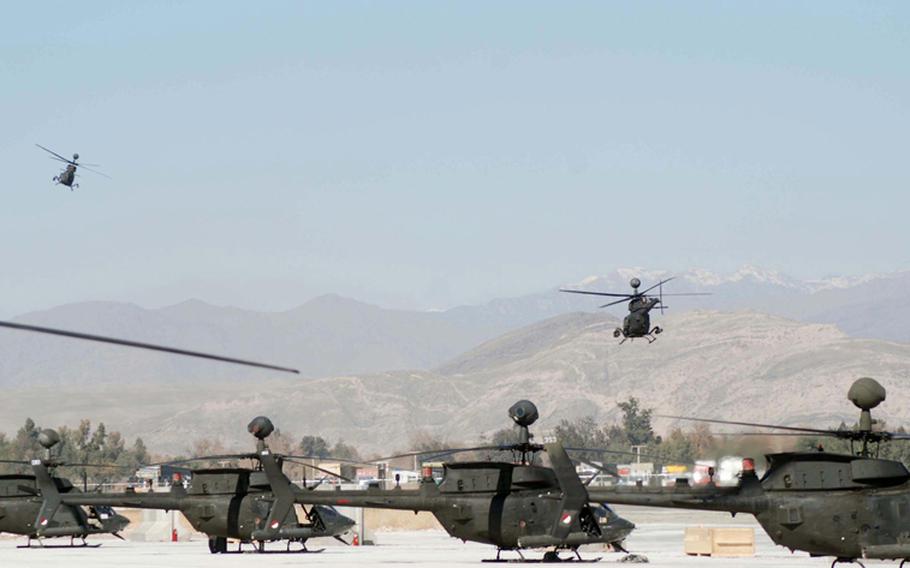 Several Kiowa Warrior helicopters sit on the flight line of Jalalabad Airfield in Afghanistan Feb. 17, 2008.