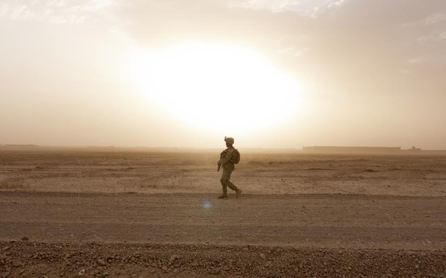 In this file photo from April 2012, a Georgian soldier with Company A, 31st Georgian Light Infantry Battalion, scans for enemy activity while on patrol in Helmand province, Afghanistan. The Georgians' mission is to provide security for the local area and a main supply route. 