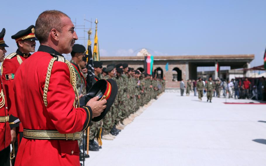 Afghan National Army band members and soldiers stand in formation outside Bagram Air Field, Parwan province, Afghanistan, on Sept. 10, 2012. The soldiers were part of a ceremony giving the Afghan government control of the local prison.