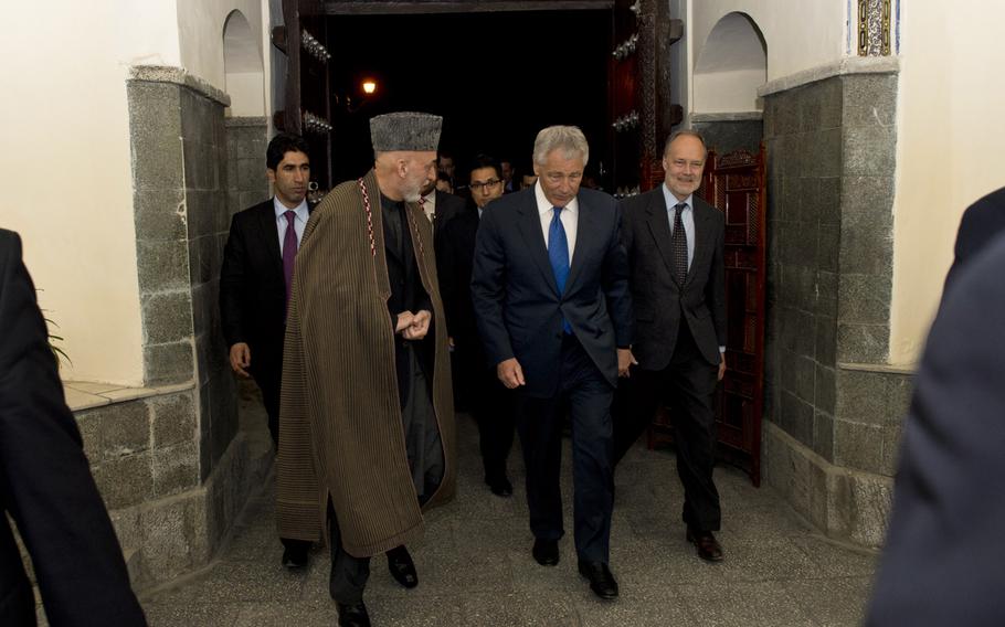 Secretary of Defense, Chuck Hagel, walks with Afghan president Hamid Karzai, March 10, 2013. Hagel is traveling to Afghanistan on his first trip as the 24th Secretary of Defense to visit U.S. Troops, NATO leaders, and Afghan counterparts.