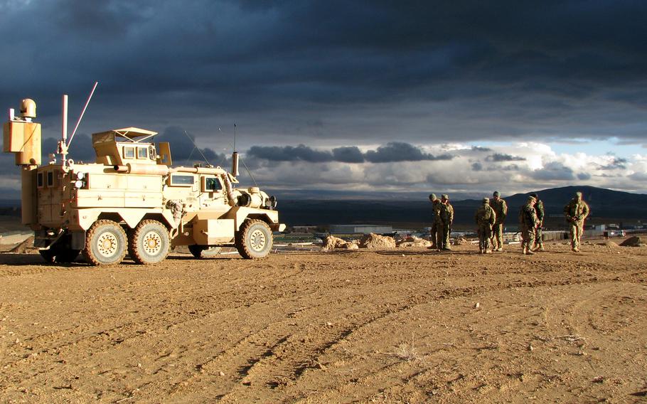 In this file photo, a group of U.S. Army advisers wrap up a day of training Afghan National Army to disarm improvised explosive devices at a training center in Qalat, Afghanistan.