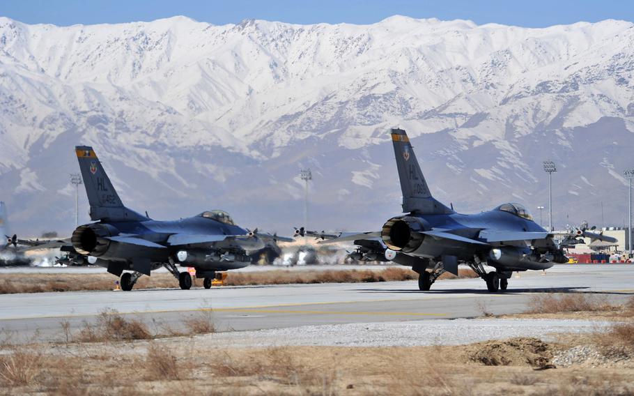 Two F-16 Fighting Falcons wait as they prepare to taxi toward the end of the runway at Bagram Air Field, Afghanistan, in this March 2011 photo. A U.S. fighter pilot was killed when his F-16 jet crashed April 3, 2013 near the base, officials said.