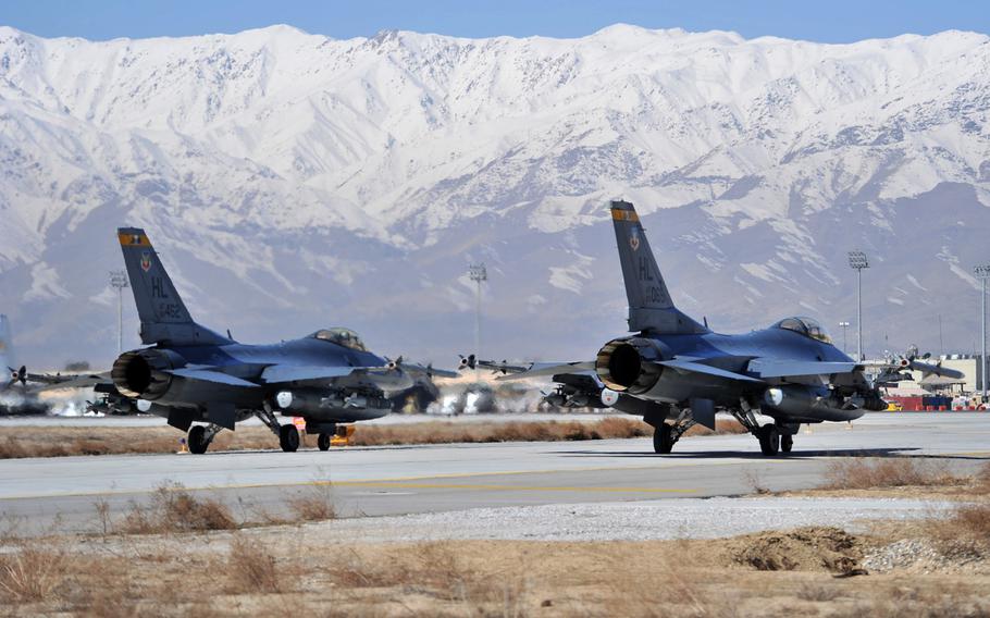 Two F-16 Fighting Falcons wait as they prepare to taxi toward the end of the runway at Bagram Air Field, Afghanistan, in this March 2011 photo. A U.S. fighter pilot was killed when his F-16 jet crashed April 3, 2013 near the base, officials said.
