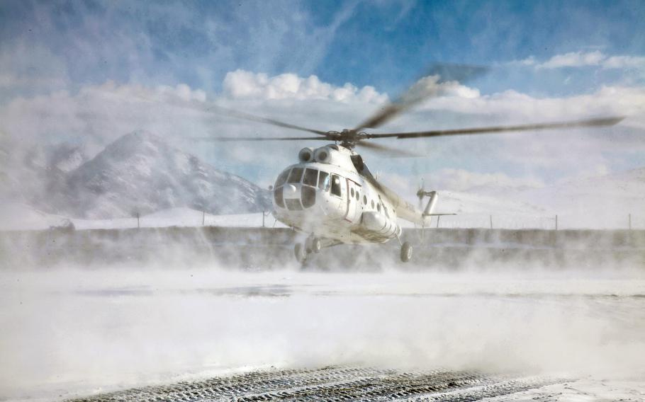 In this file photo, a Russian made Mil Mi-8 helicopter lands at Forward Operating Base Airborne, Afghanistan, after a two-day snow storm. On April 22, 2013, Taliban took 10 foreigners hostage when a helicopter similar to the one pictured made an emergency landing in volatile area of Afghanistan. 


