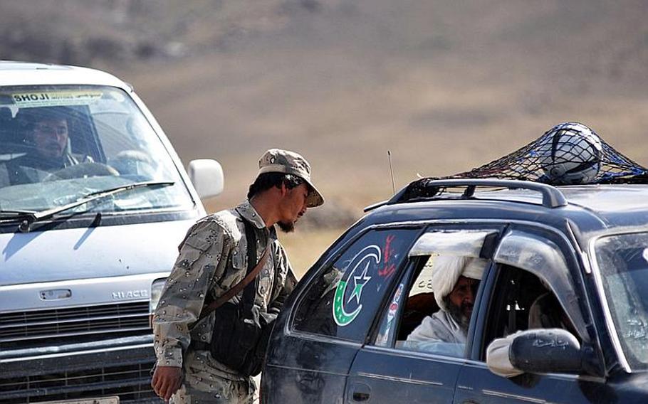 Ghais, an Afghan Border Police officer, searches a vehicle at a checkpoint along Highway 4 between Forward Operating Base Spin Boldak and Kandahar, Afghanistan. Afghan troops destroyed a disputed Pakistani border station after a deadly overnight clash, Afghan authorities said Thursday.
