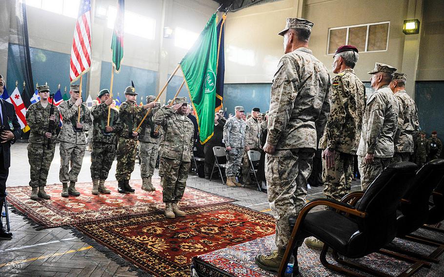 Gen. Joseph F. Dunford, on the left of the podium, commander of ISAF in Afghanistan, assumes command from Gen. John Allen at a change of command ceremony in Kabul, Afghanistan, Feb. 10, 2013.