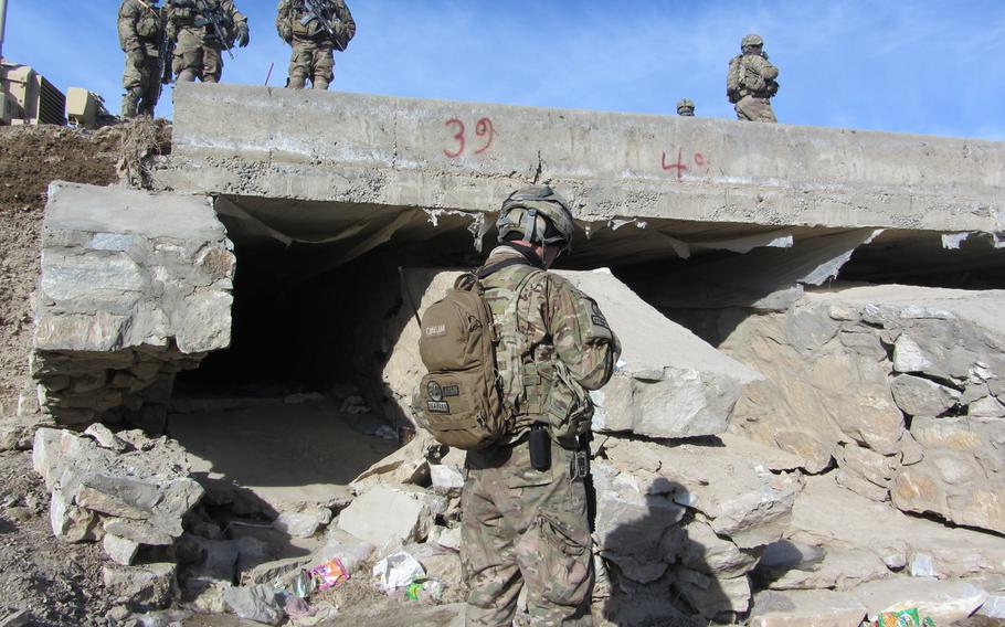 Servicemembers inspect an open culvert in Afghanistan. A report released by the Special Inspector General for Afghanistan Reconstruction on July 23, 2013, detailed fraud and negligence in the installation of grates to block insurgents from placing bombs in culverts running under roads.


