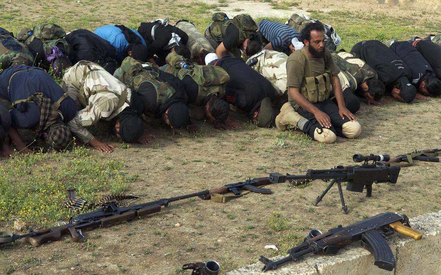 Syrian rebels from the Grandsons of the Prophet Brigades pray before a battle at Abu Duhor miltiary airport in northern Syria. Rebels have continued offensives in northern and central Syria even as ammunition and other support for them has slowed in past months. 