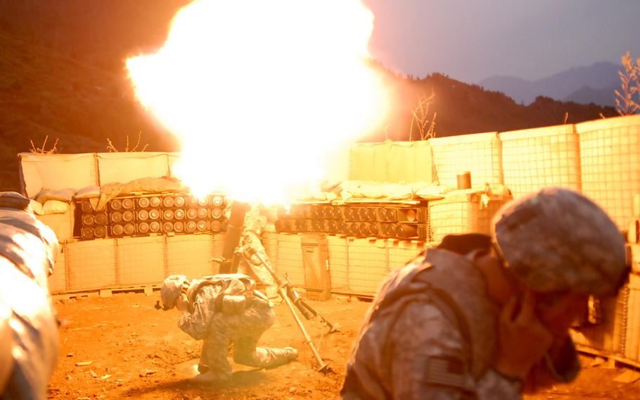 Soldiers at a combat outpost in Konar province's Gowardesh Valley fire a mortar in later September. With troops spread thin, units use air power and indirect fire to outgun insurgents. 