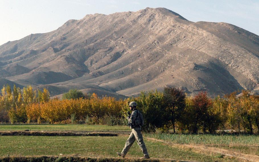 A soldier with 3rd Platoon, Company A, 2nd Battalion, 87th Infantry Regiment moves toward the site of a roadside bomb in the Tangi valley.