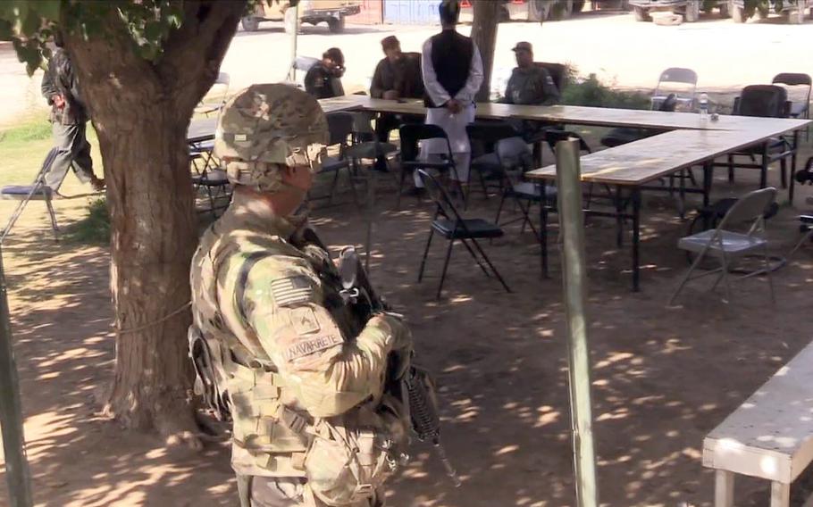 A U.S. servicemember stands guard in Afghanistan