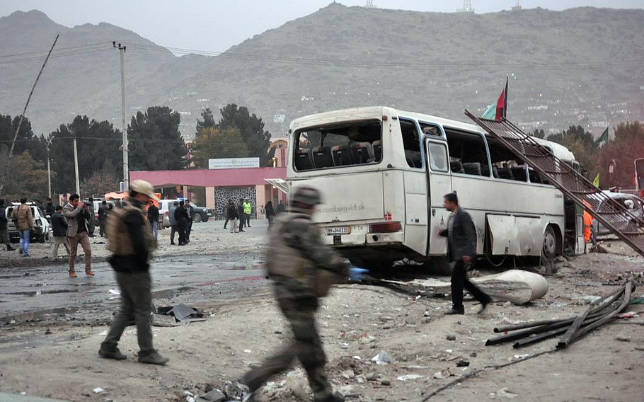 A damaged bus sits on the side of a road after a suicide car bomb attack Saturday, Nov. 16, 2013, in Kabul just across the street from a popular literature university in Kabul.

Alex Pena/Stars and Stripes 