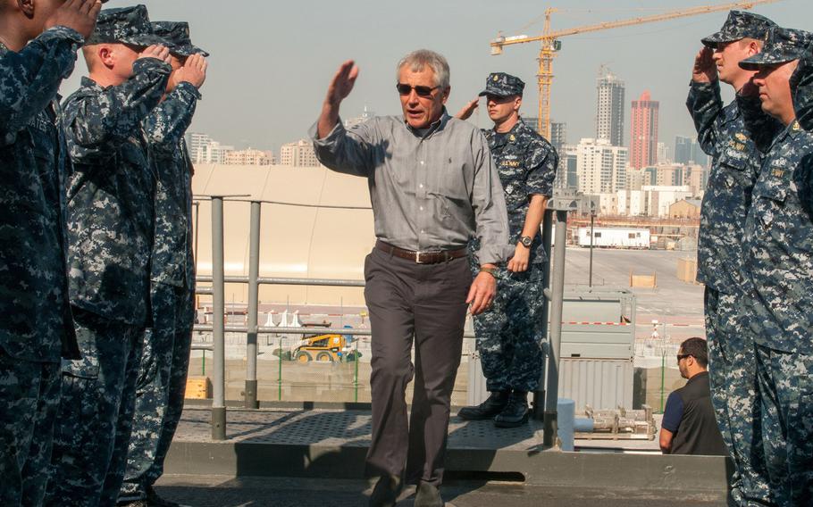 Defense Secretary Chuck Hagel salutes sideboys upon arriving aboard the afloat forward staging base USS Ponce Dec. 6, 2013. Hagel is currently visiting Bahrain to attend an annual meeting of Gulf-area defense chiefs.  